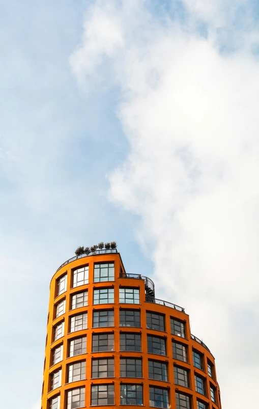 an orange building with lots of windows and a small bird sitting on top of the window