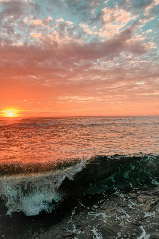 a surfer sits on a wave in the ocean