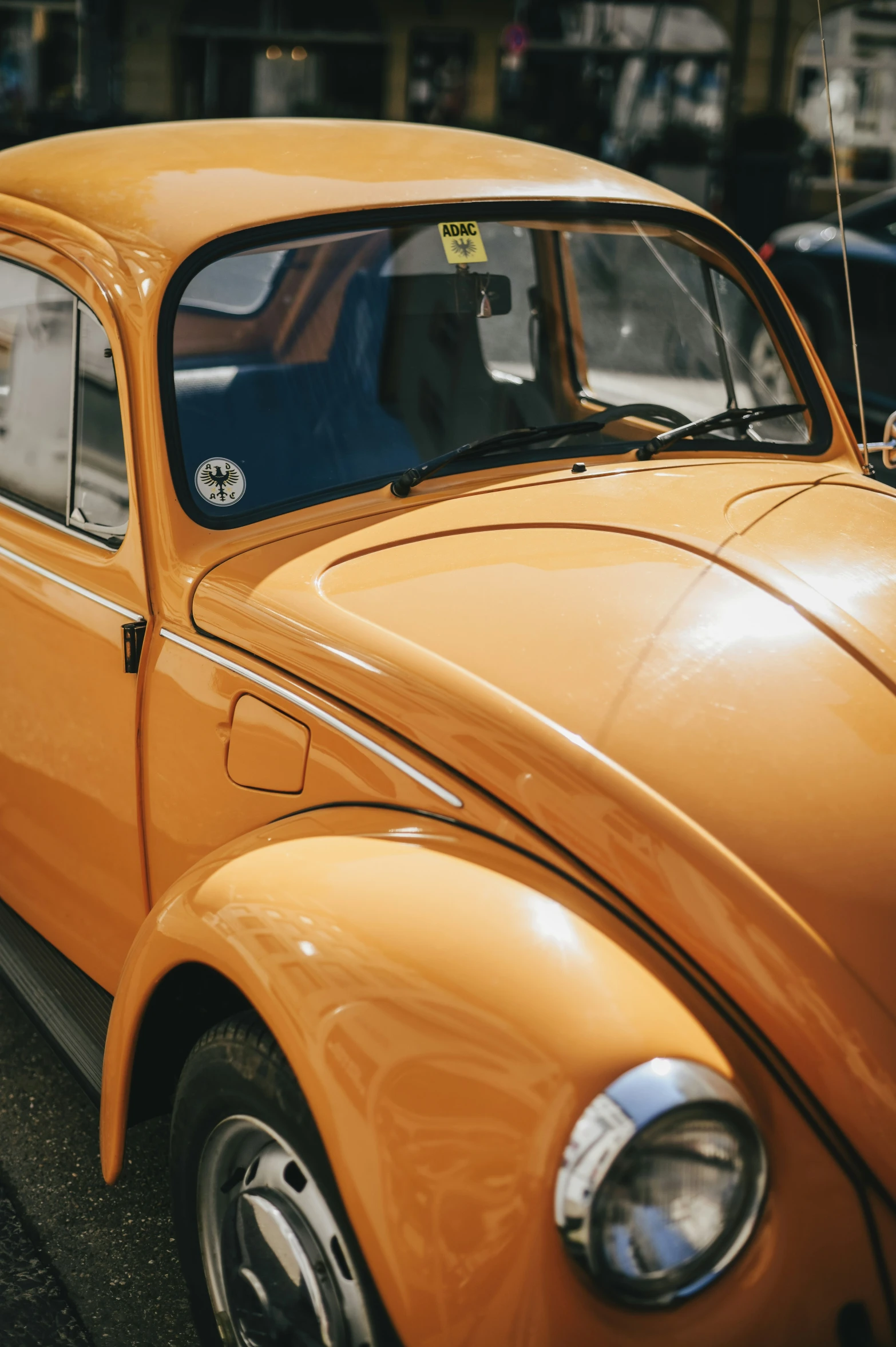 a yellow car sitting on the side of the road