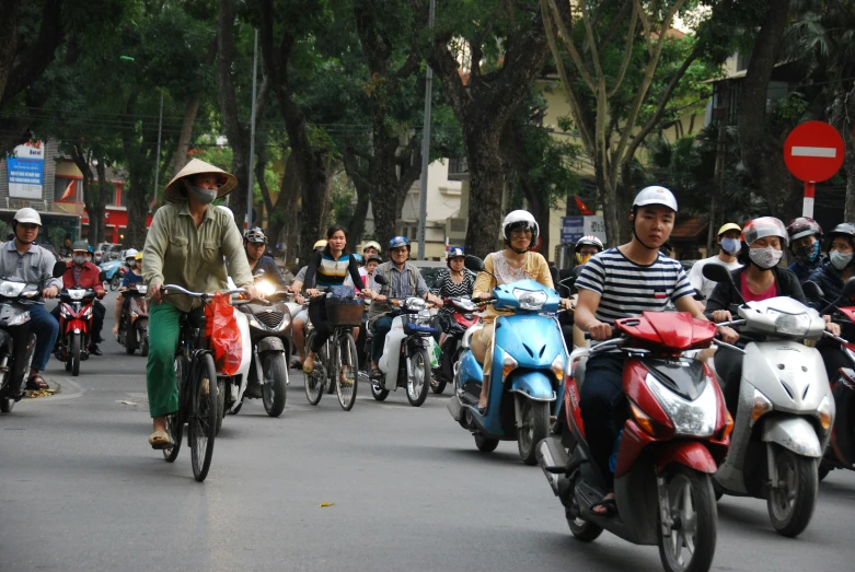 people are riding motor bikes in the street