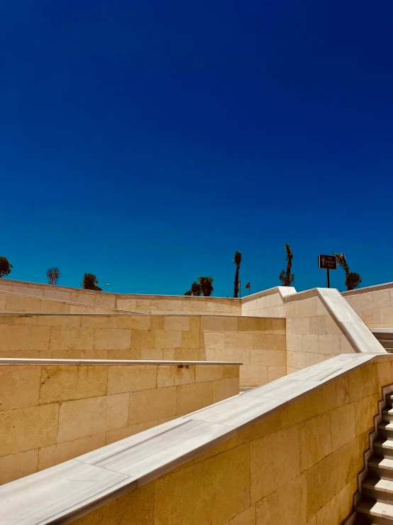 a concrete wall and some steps with a bench