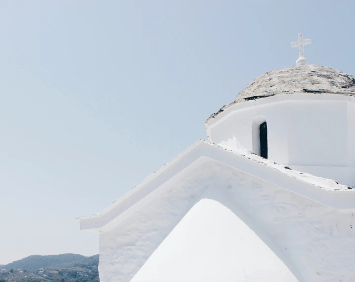 a church steeple with a cross on top of it