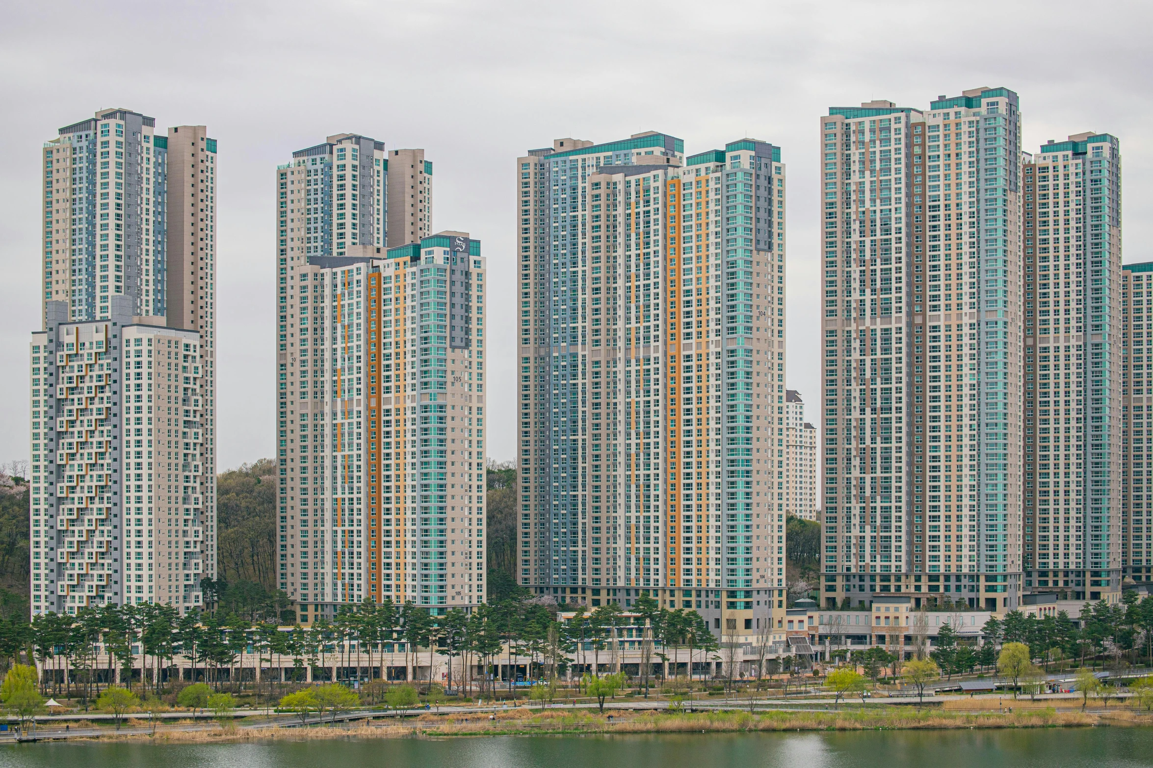 the tall buildings next to the water line are blue