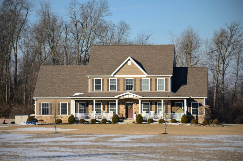 the large, two - story house has three stories and many windows