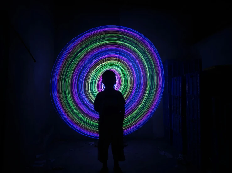 a man in dark room with colored lights