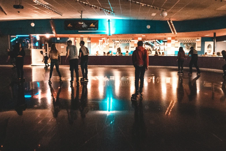 a group of people standing around in the middle of an airport