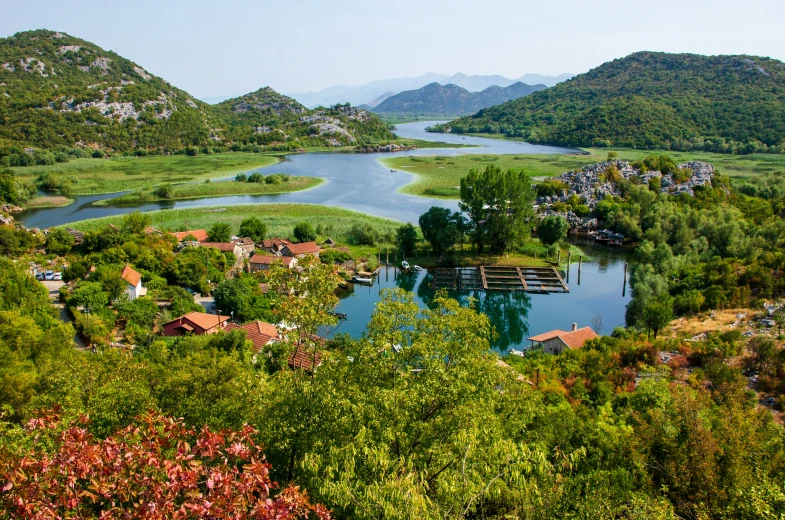 a river running through a lush green countryside