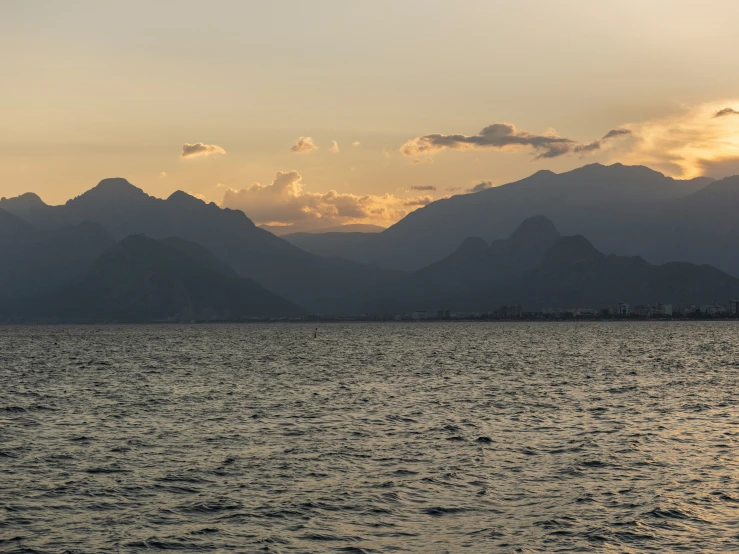 a large body of water sitting below mountains