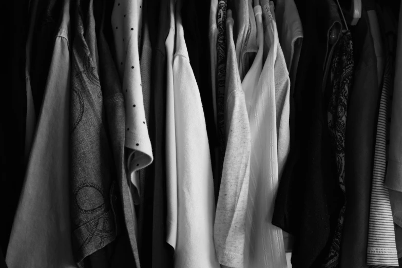 a row of clothes hanging in black and white