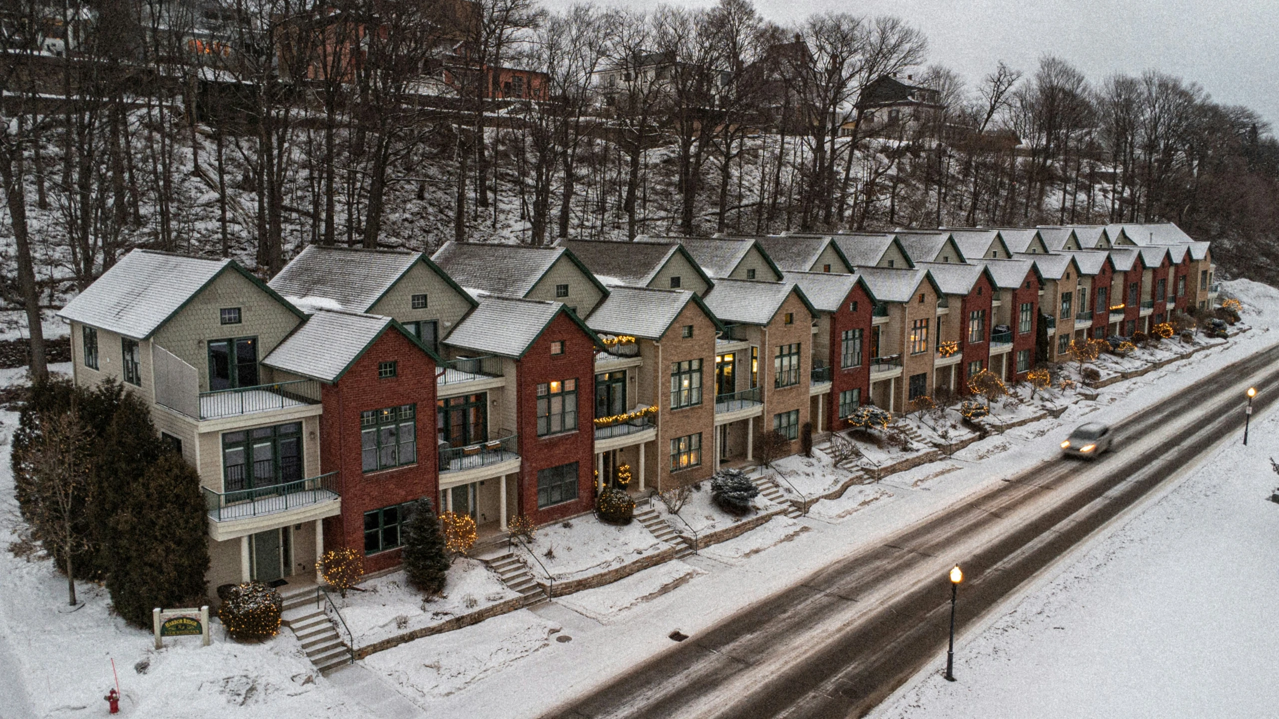 a group of houses with a few cars parked