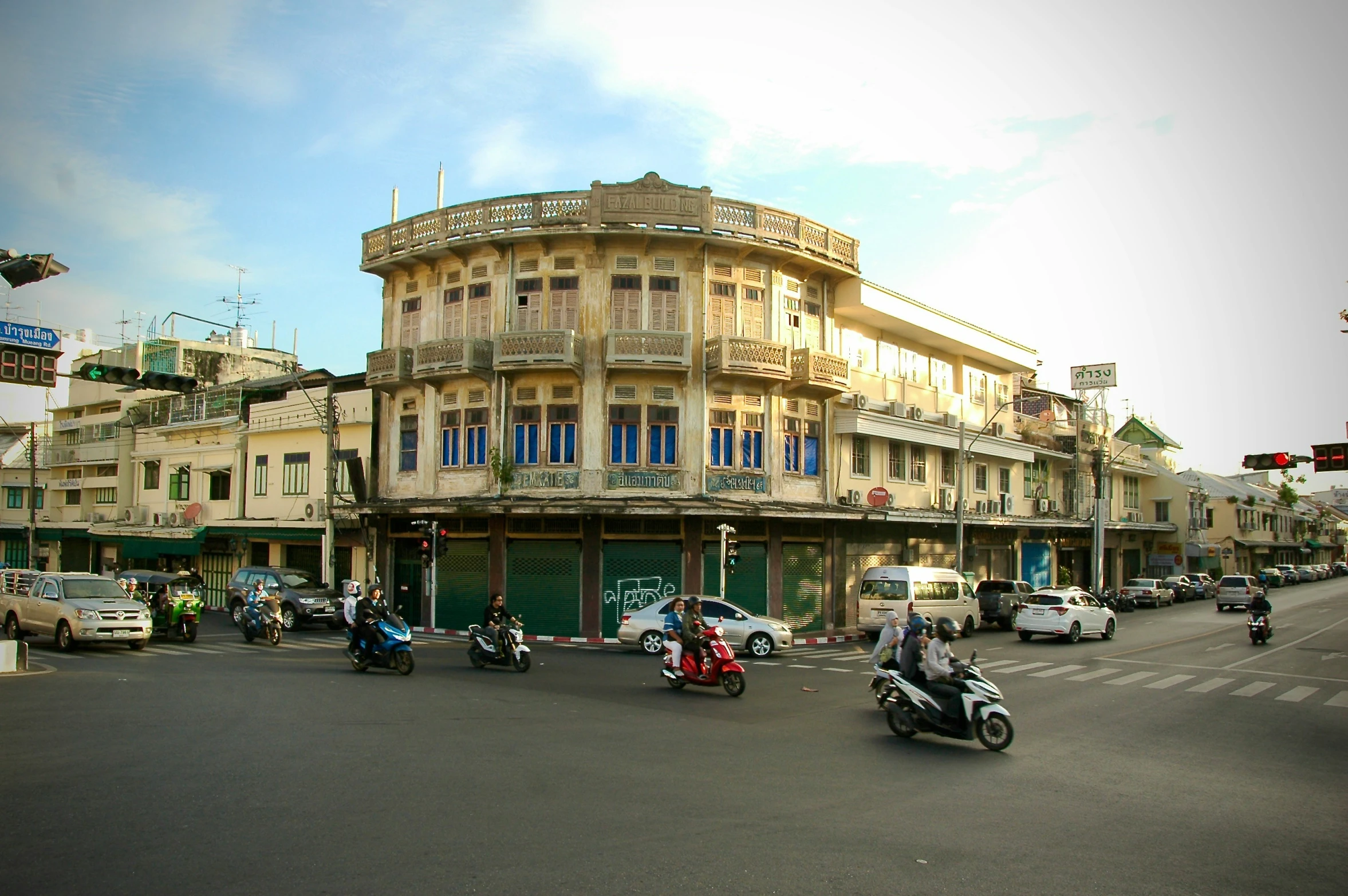 many cars and motorcycles are driving down a city street