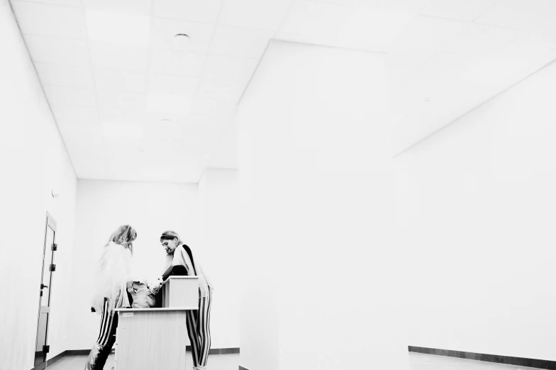 a person sitting on a bench in the middle of a hallway