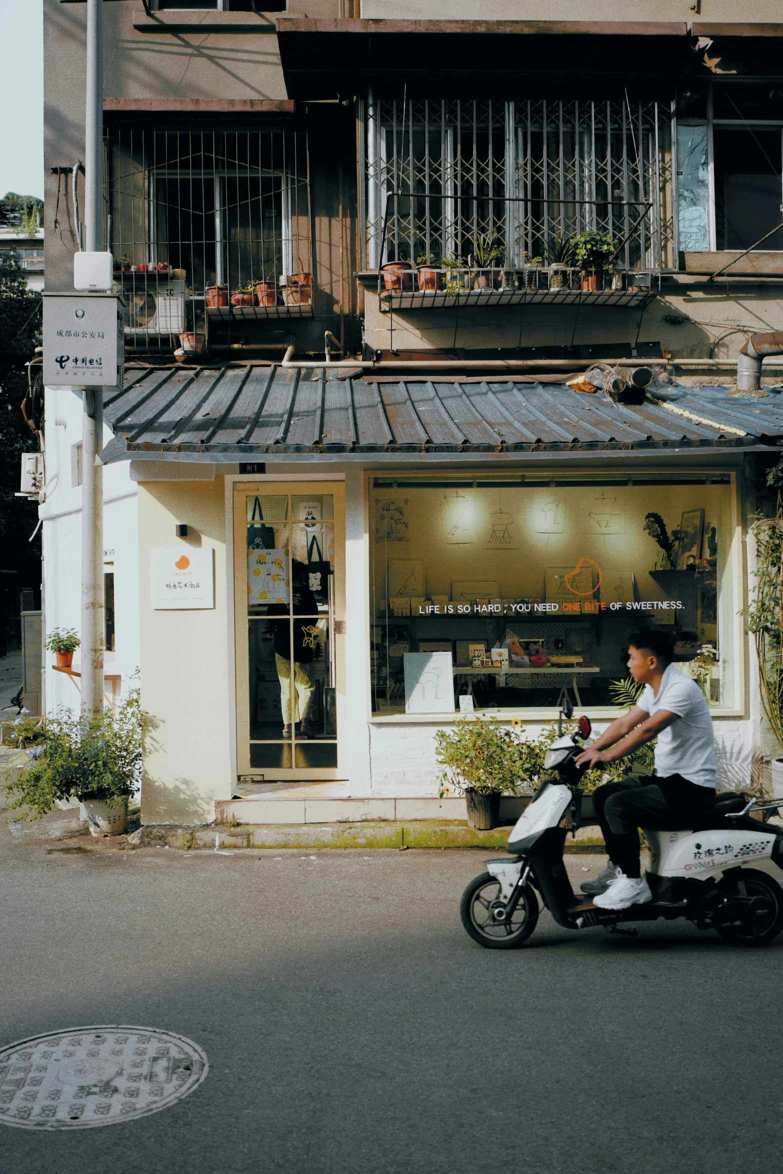 a man riding a scooter down the middle of a street