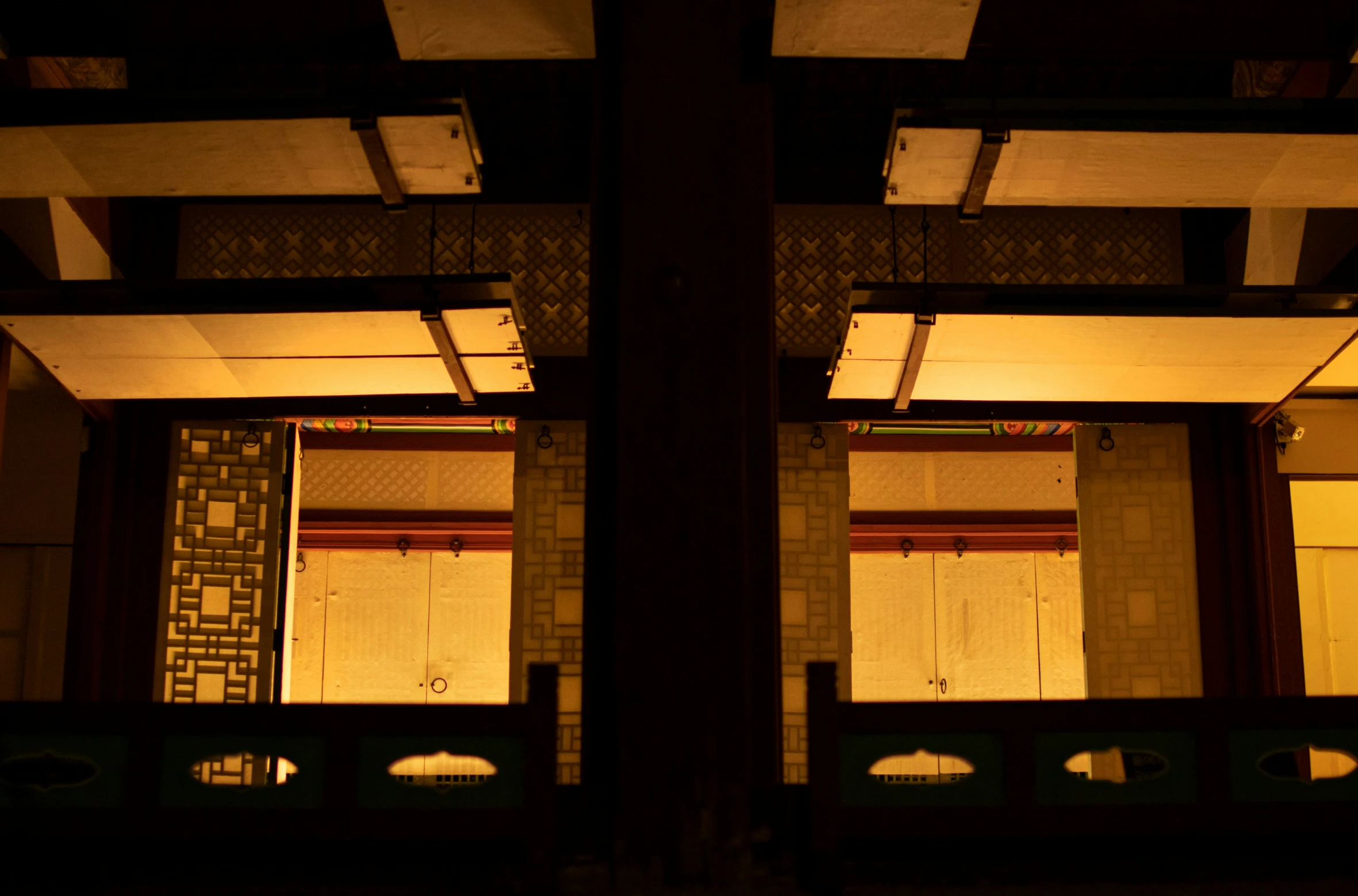 the image of a building at night is taken through a window