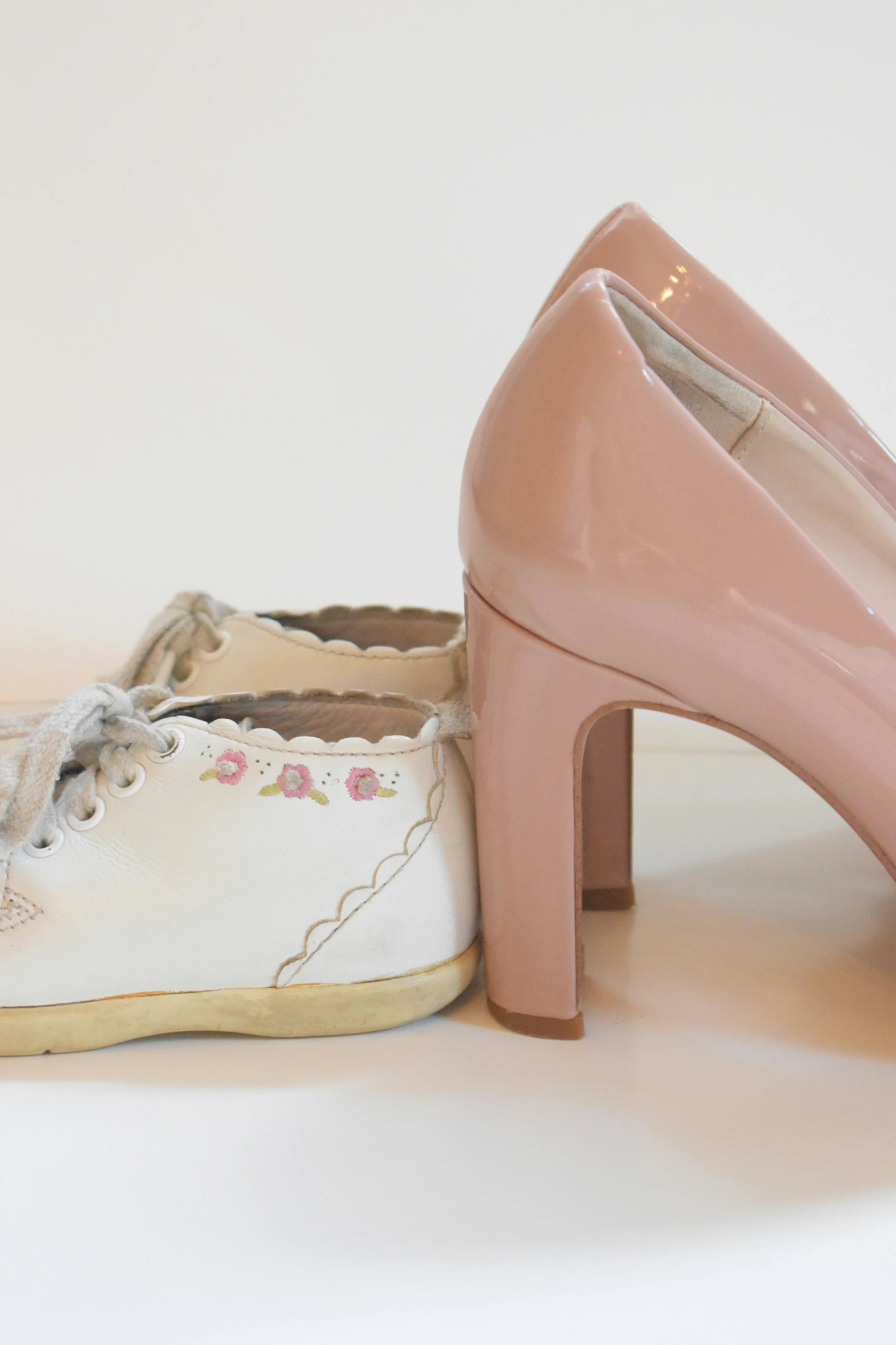 a pair of pink and white shoes sitting next to each other