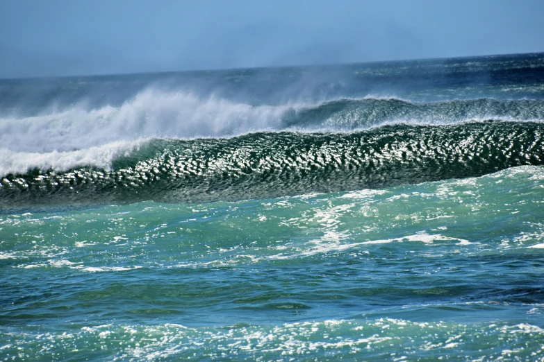 a person on a surfboard riding a wave