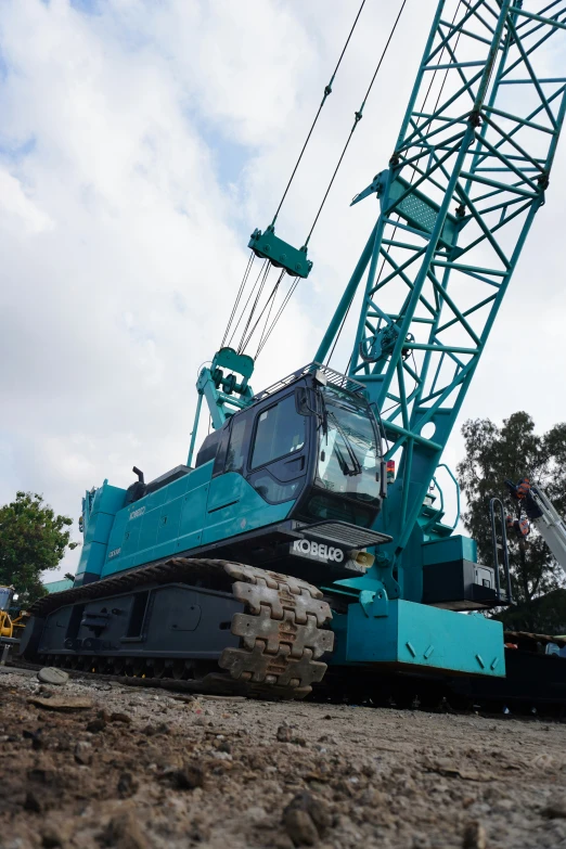 a crane sits in the middle of some dirt