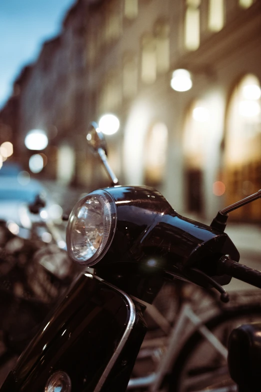 motorcycles parked in a lot with some lights on