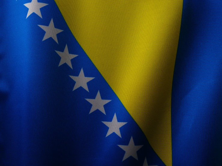 the yellow and blue flag with some white stars on it