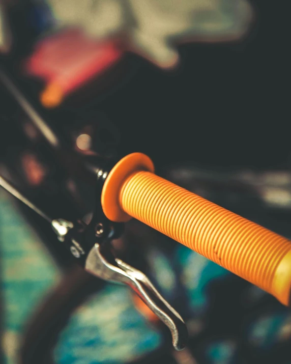 a pair of scissors with an orange handle