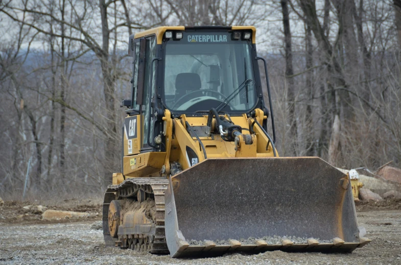 a construction vehicle is sitting in the dirt