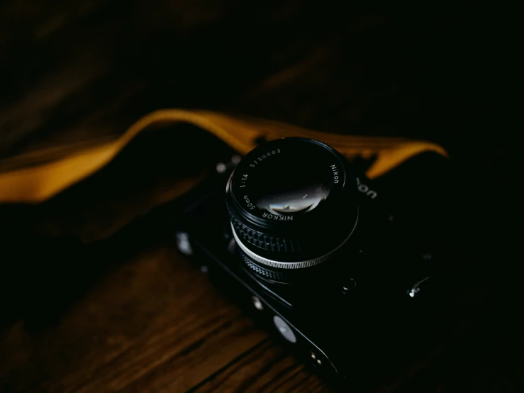 a small camera on a table with some cloths