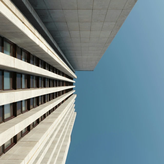 looking up at two large building with windows