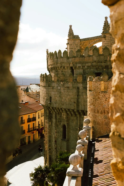 a stone tower sits next to an old building