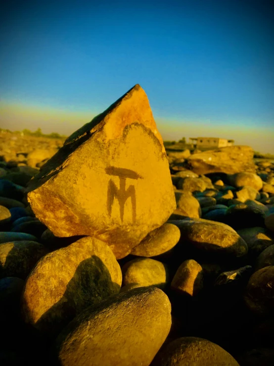 a rock with a picture of a man painted on it