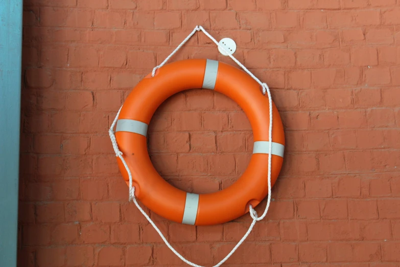 an orange life preserver hanging from the side of a building