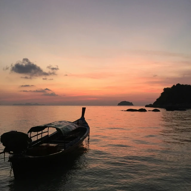 a boat floating on the water with a sky background