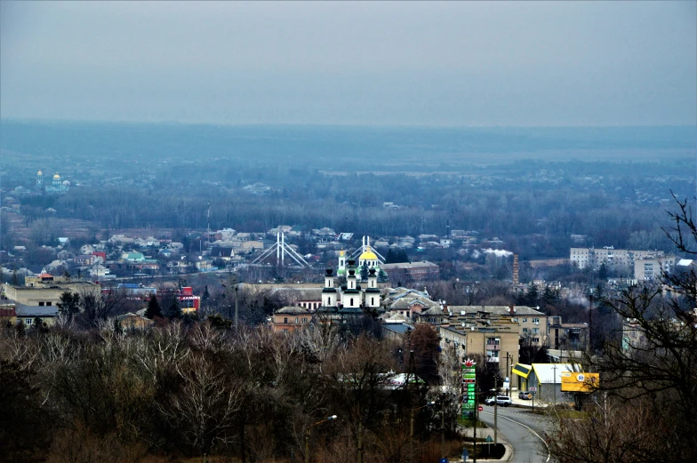 a city view overlooking a valley and a large tower