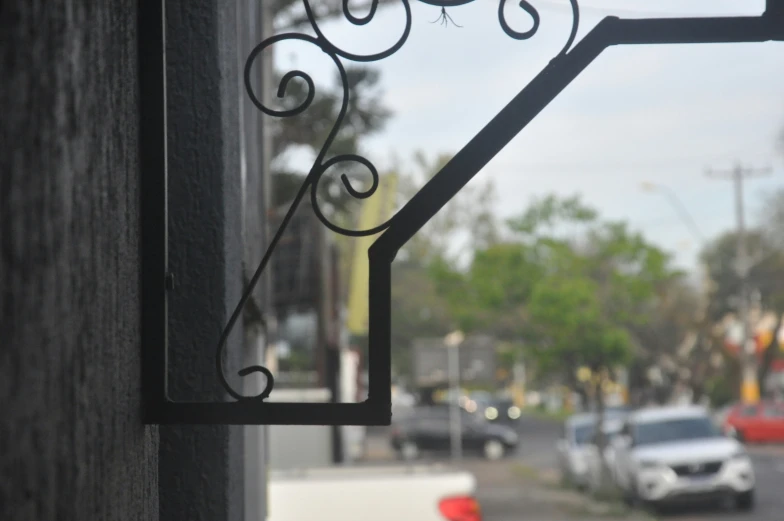 a window with some iron designs on the side of it