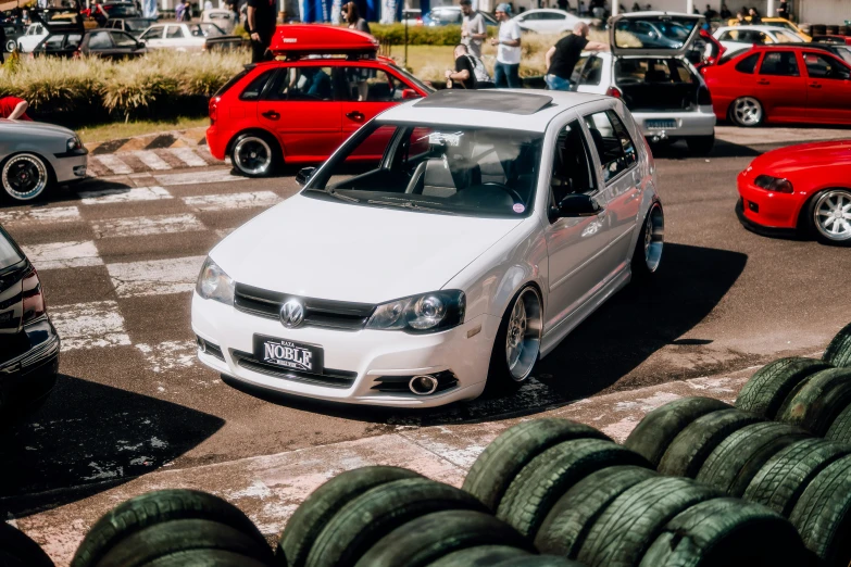 a white car parked in the middle of some very nice looking traffic