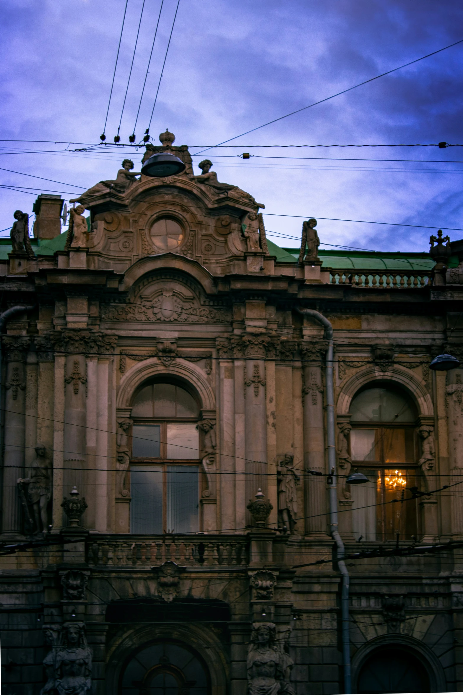 there is a large brown building with a clock on top