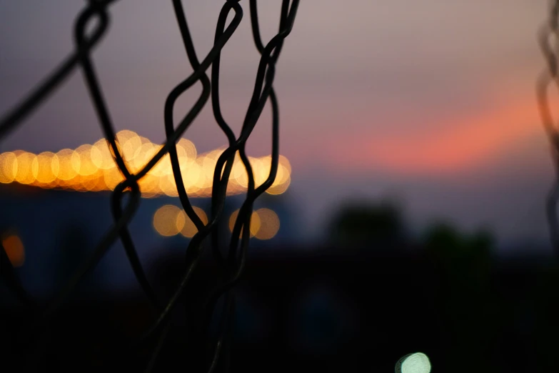 a fence with the night sky visible in the background