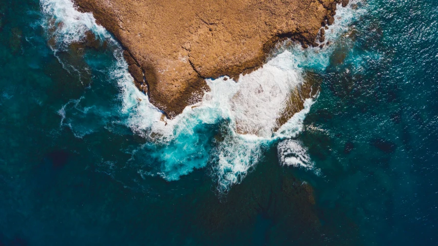 water and rocks with a white spray of water on it