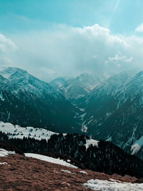 a view of mountains with snow in the foreground