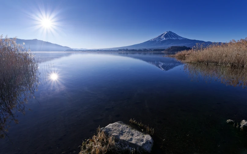 a body of water surrounded by a mountain