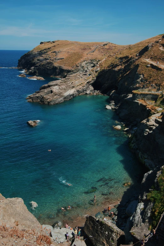 several people are swimming in clear blue water