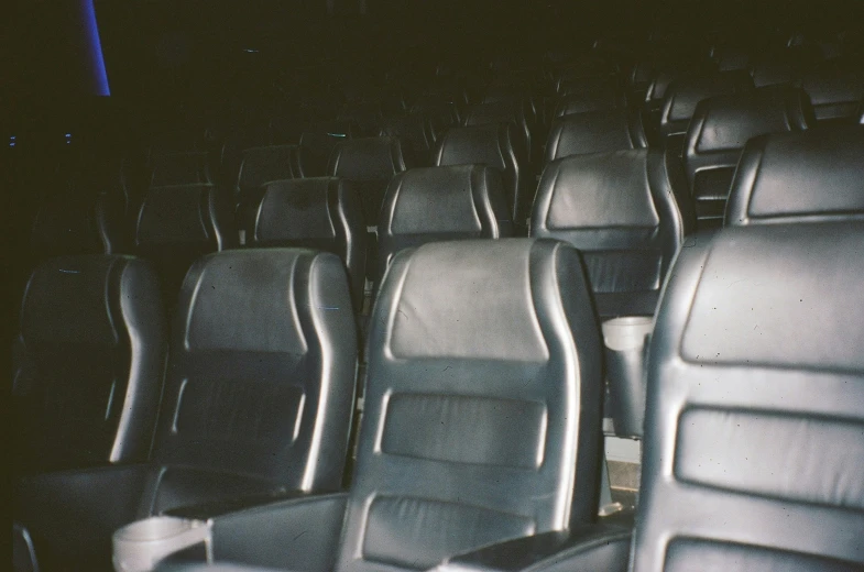 rows of grey leather seats in theater or theater