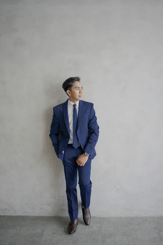 a young man in a suit posing for a po