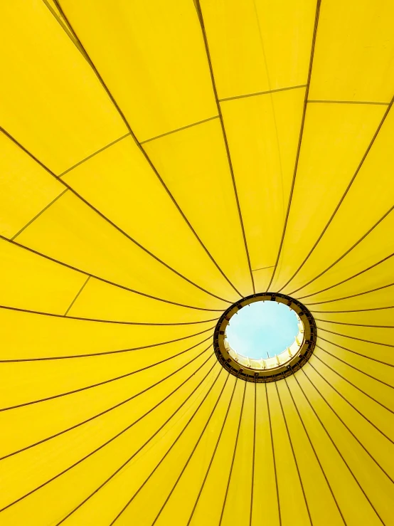 the inside of an umbrella showing the bright yellow colors
