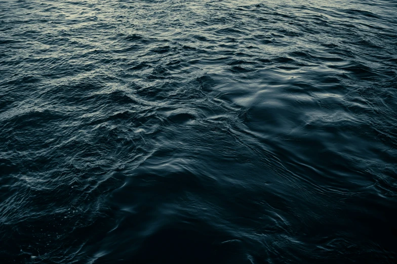 an ocean view with water waves and some clouds