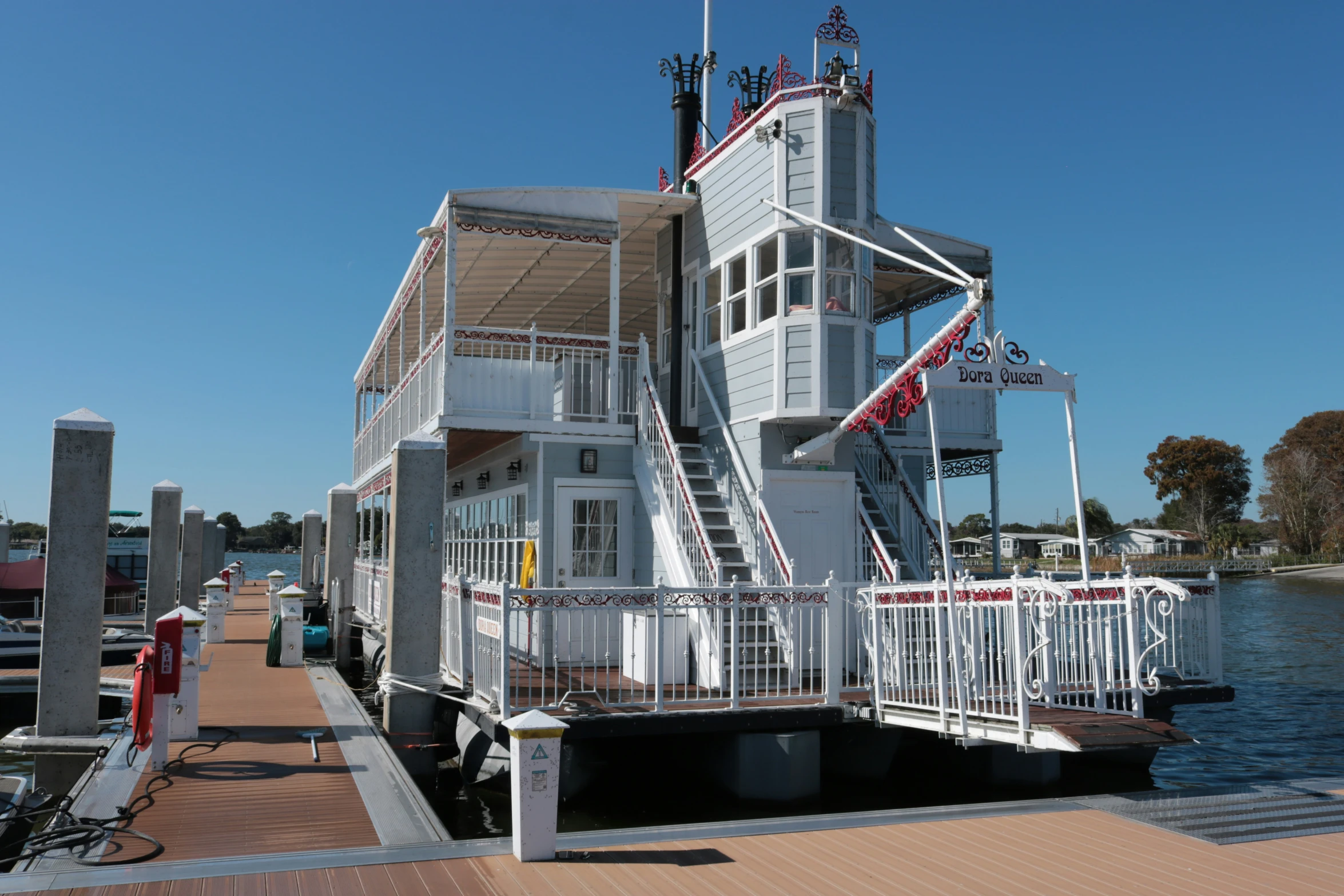 a white house with several windows and stairs to the top and bottom of the roof