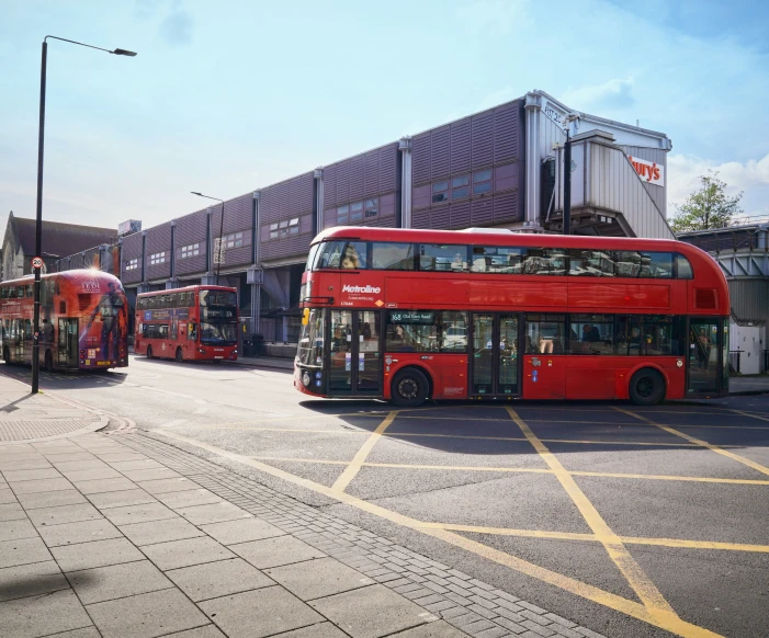 several double decker buses parked in a lot