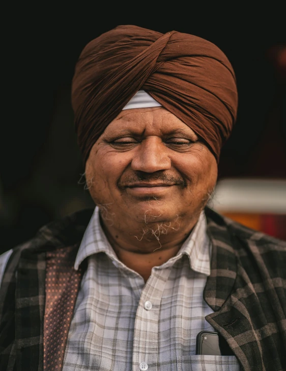 an old man with a turban and tie