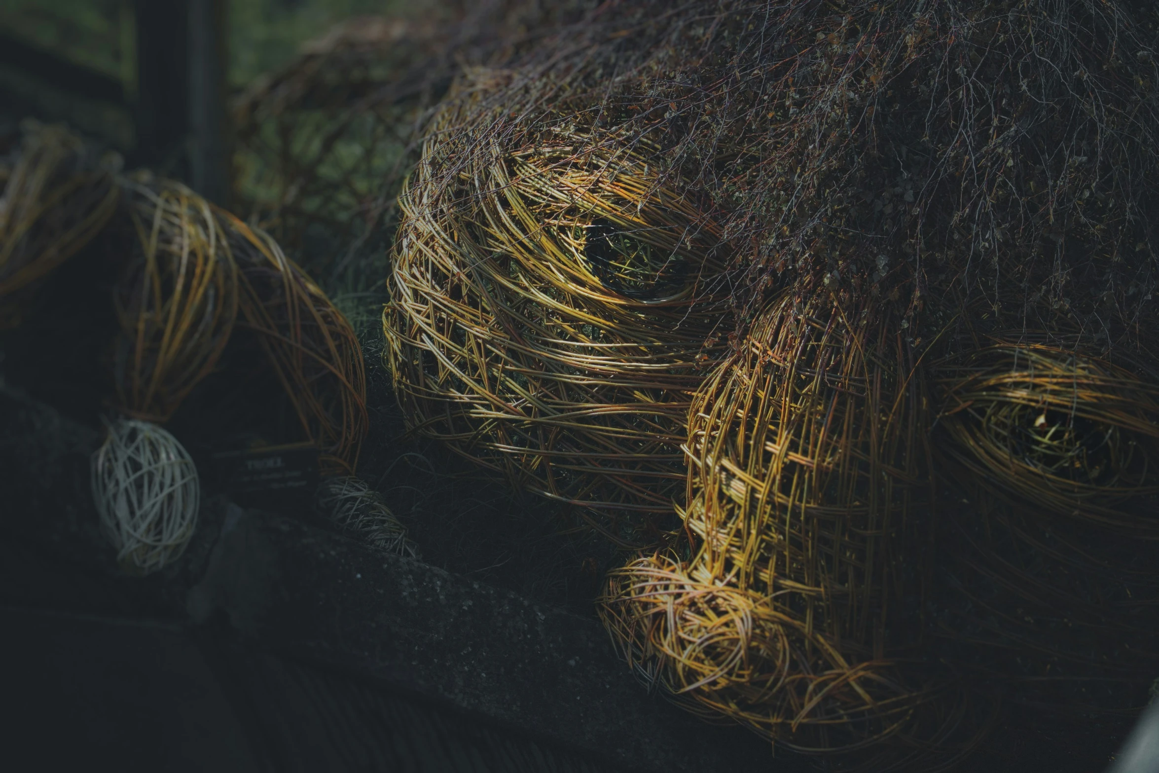 a wire elephant head sitting next to another elephant head