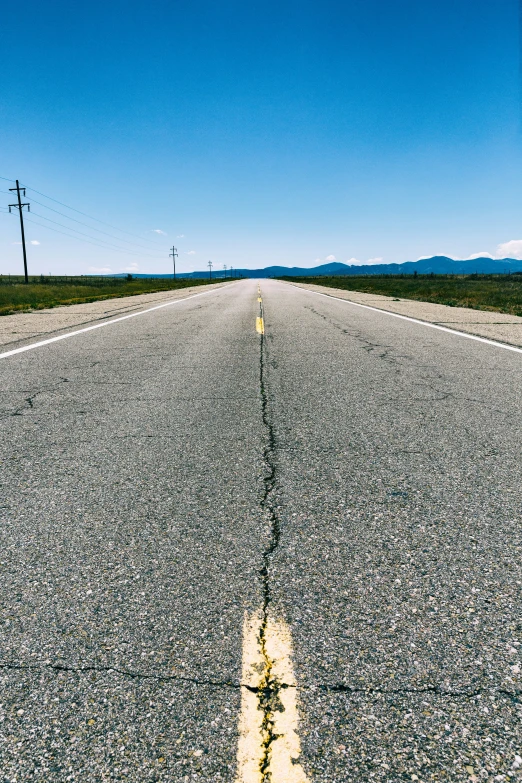 a view of the empty road with the grass in front