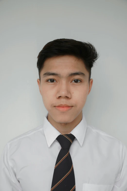 a young man wearing a striped tie posing for the camera